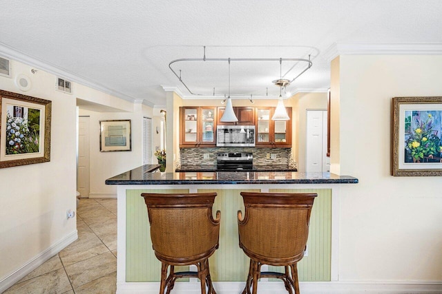 3606 S Ocean Blvd Unit 201, Highland Beach, FL 33487 - kitchen featuring stainless steel appliances, crown molding, backsplash, baseboards, and a kitchen bar