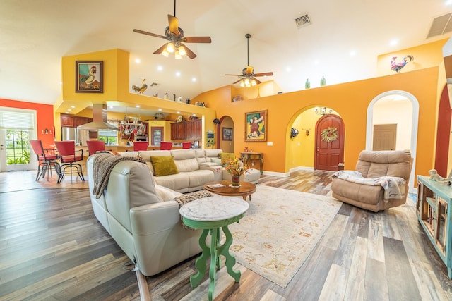 7611 SW 21st Pkwy, Okeechobee, FL 34974 - living room with arched walkways, high vaulted ceiling, a ceiling fan, wood finished floors, and baseboards