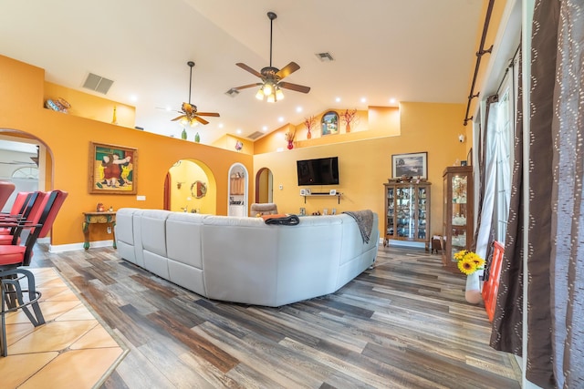 7611 SW 21st Pkwy, Okeechobee, FL 34974 - living area featuring wood finished floors, arched walkways, high vaulted ceiling, ceiling fan, and baseboards