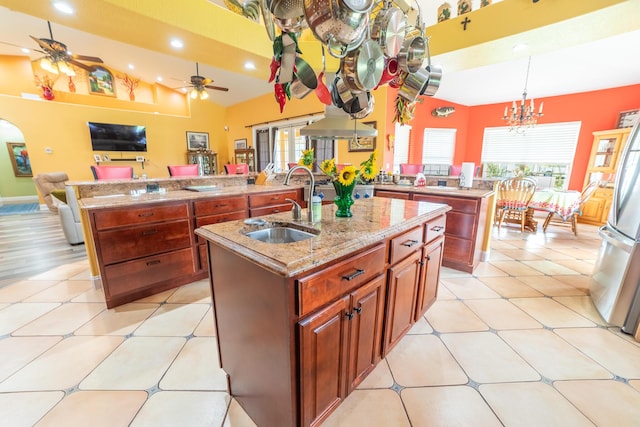 7611 SW 21st Pkwy, Okeechobee, FL 34974 - kitchen featuring an island with sink, a sink, a ceiling fan, open floor plan, and freestanding refrigerator