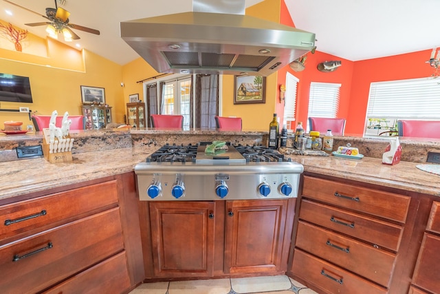 7611 SW 21st Pkwy, Okeechobee, FL 34974 - kitchen featuring island range hood, stainless steel gas cooktop, vaulted ceiling, a ceiling fan, and light stone countertops