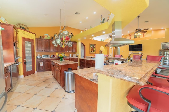 7611 SW 21st Pkwy, Okeechobee, FL 34974 - kitchen featuring island range hood, a large island with sink, arched walkways, a ceiling fan, and a kitchen bar