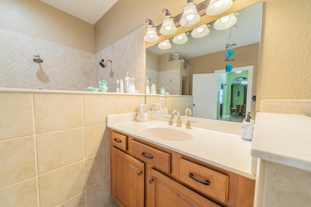 7611 SW 21st Pkwy, Okeechobee, FL 34974 - full bath featuring vanity, tiled shower, a textured wall, and tile walls