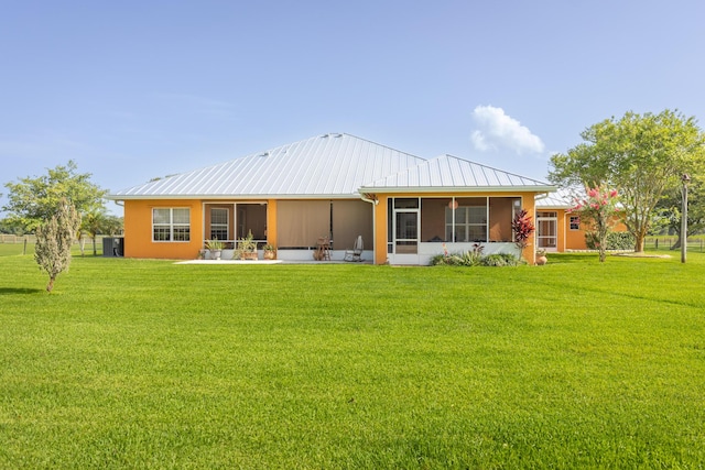 7611 SW 21st Pkwy, Okeechobee, FL 34974 - rear view of property with a sunroom, a lawn, a standing seam roof, and metal roof