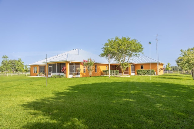 7611 SW 21st Pkwy, Okeechobee, FL 34974 - rear view of house with a yard, metal roof, and a sunroom