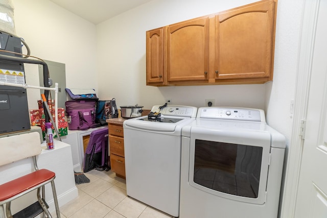 7611 SW 21st Pkwy, Okeechobee, FL 34974 - laundry room featuring washer and dryer, cabinet space, and light tile patterned flooring