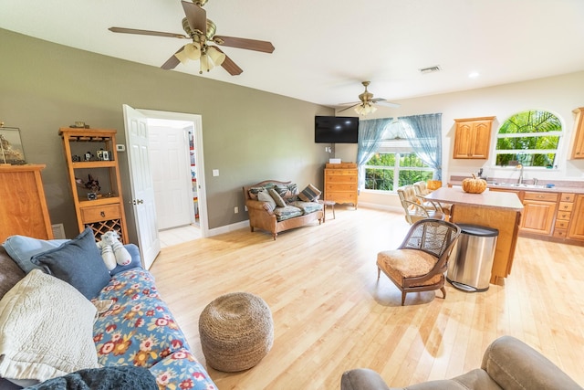 7611 SW 21st Pkwy, Okeechobee, FL 34974 - living room featuring ceiling fan, light wood-style flooring, and baseboards