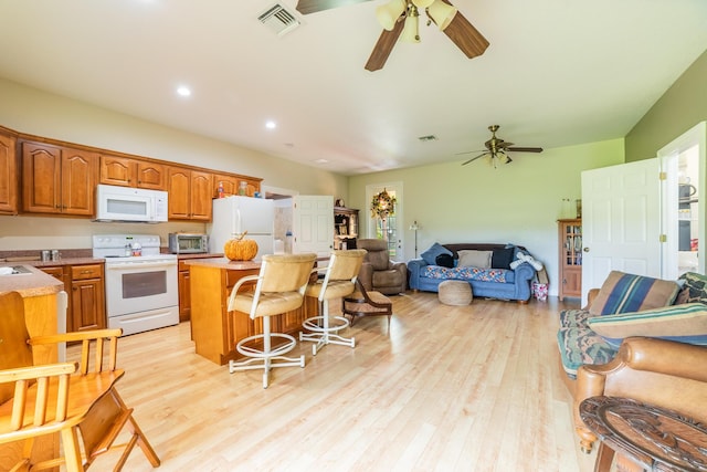 7611 SW 21st Pkwy, Okeechobee, FL 34974 - kitchen featuring white appliances, open floor plan, ceiling fan, a center island, and recessed lighting