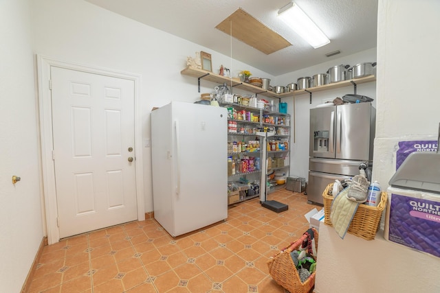 7611 SW 21st Pkwy, Okeechobee, FL 34974 - kitchen featuring stainless steel fridge with ice dispenser, freestanding refrigerator, and open shelves