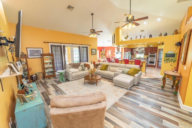 7611 SW 21st Pkwy, Okeechobee, FL 34974 - living room with high vaulted ceiling, a ceiling fan, and light wood-style flooring