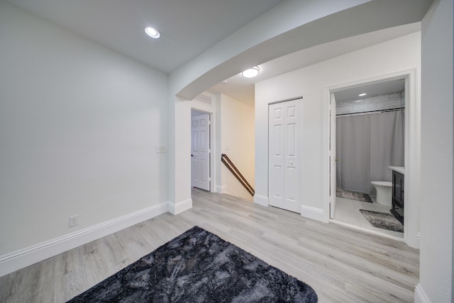 2364 Center Stone Ln, Riviera Beach, FL 33404 - below grade area with arched walkways, light wood finished floors, baseboards, and recessed lighting