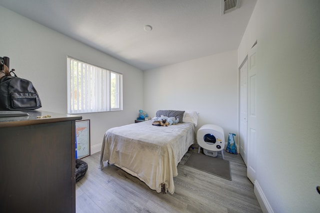 2364 Center Stone Ln, Riviera Beach, FL 33404 - bedroom with baseboards and light wood finished floors