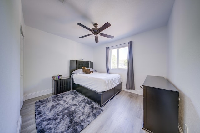 2364 Center Stone Ln, Riviera Beach, FL 33404 - bedroom with wood finished floors, baseboards, and ceiling fan