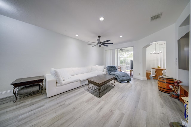 2364 Center Stone Ln, Riviera Beach, FL 33404 - living area featuring a chandelier, wood finished floors, arched walkways, baseboards, and recessed lighting