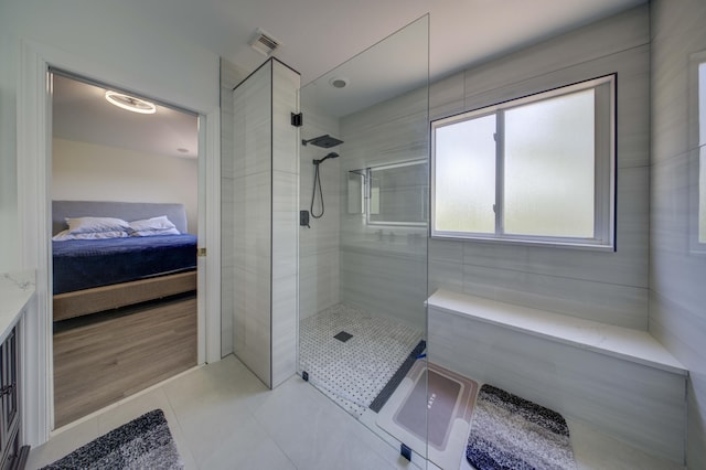 2364 Center Stone Ln, Riviera Beach, FL 33404 - bathroom with tiled shower, ensuite bath, and tile patterned floors