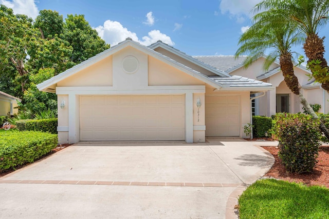 10312 Inverness Way, Port Saint Lucie, FL 34986 - single story home with stucco siding, a garage, concrete driveway, and a tiled roof