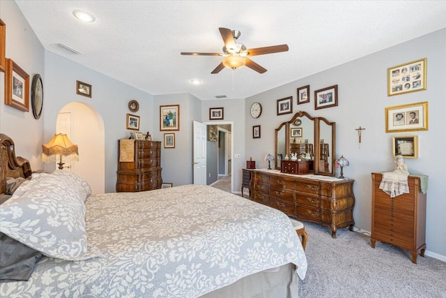 10312 Inverness Way, Port Saint Lucie, FL 34986 - bedroom featuring light carpet, arched walkways, a ceiling fan, recessed lighting, and a textured ceiling