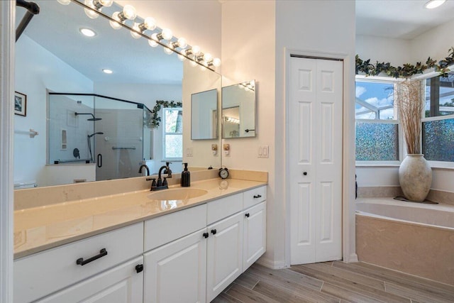 10312 Inverness Way, Port Saint Lucie, FL 34986 - full bathroom featuring a garden tub, vanity, a shower stall, wood finished floors, and recessed lighting