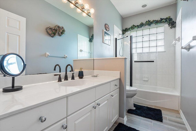 10312 Inverness Way, Port Saint Lucie, FL 34986 - full bathroom featuring toilet, vanity, wood finished floors, shower / washtub combination, and baseboards