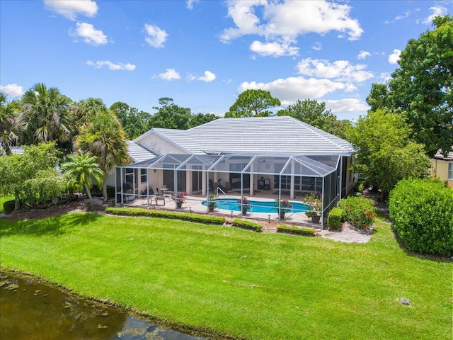 10312 Inverness Way, Port Saint Lucie, FL 34986 - rear view of house with a patio, an outdoor pool, a yard, and a tile roof