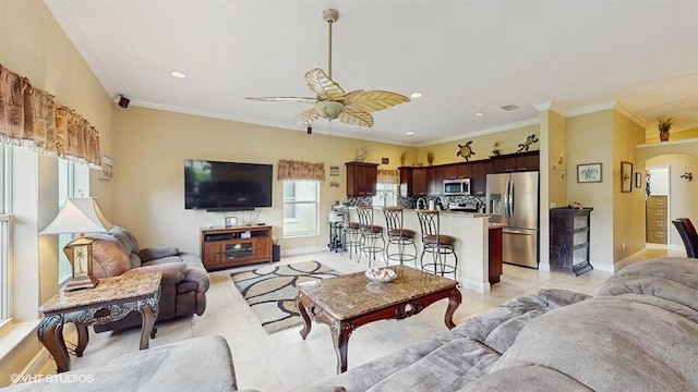 2127 NW Tilia Trl, Stuart, FL 34994 - living room featuring ceiling fan, light tile patterned floors, crown molding, baseboards, and arched walkways