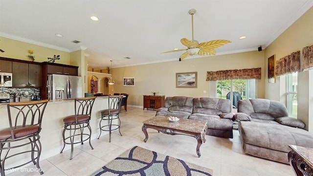 2127 NW Tilia Trl, Stuart, FL 34994 - living room with light tile patterned floors, ornamental molding, a ceiling fan, and recessed lighting
