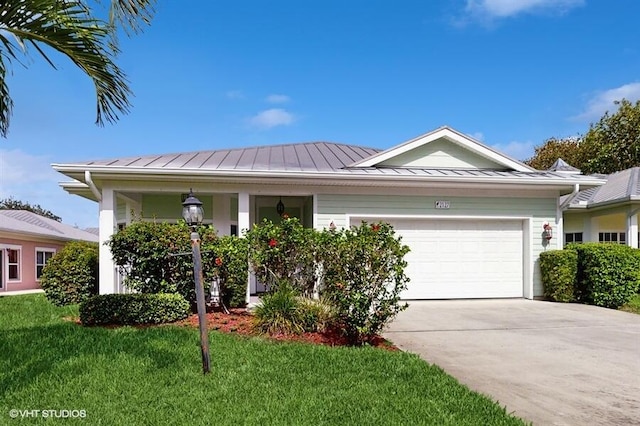 2127 NW Tilia Trl, Stuart, FL 34994 - ranch-style home featuring a standing seam roof, an attached garage, a front lawn, driveway, and metal roof
