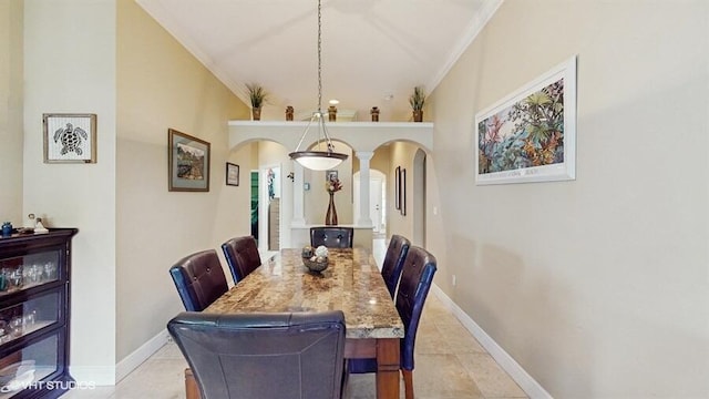 2127 NW Tilia Trl, Stuart, FL 34994 - dining area featuring arched walkways, crown molding, baseboards, and light tile patterned floors
