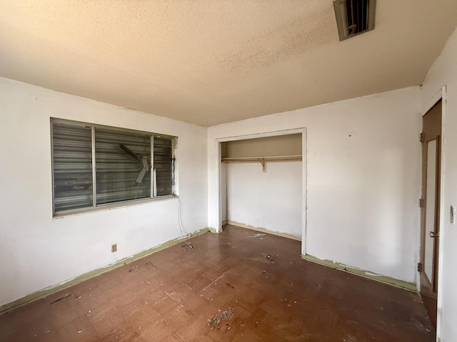 1376 Meadowbrook Dr, West Palm Beach, FL 33417 - unfurnished bedroom featuring a textured ceiling, a closet, and baseboards