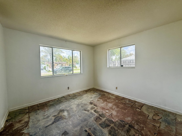 1376 Meadowbrook Dr, West Palm Beach, FL 33417 - spare room featuring baseboards and a textured ceiling