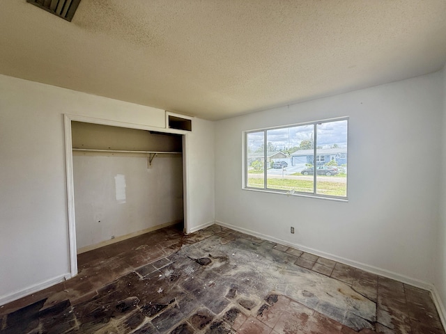 1376 Meadowbrook Dr, West Palm Beach, FL 33417 - unfurnished bedroom featuring a textured ceiling, a closet, and baseboards