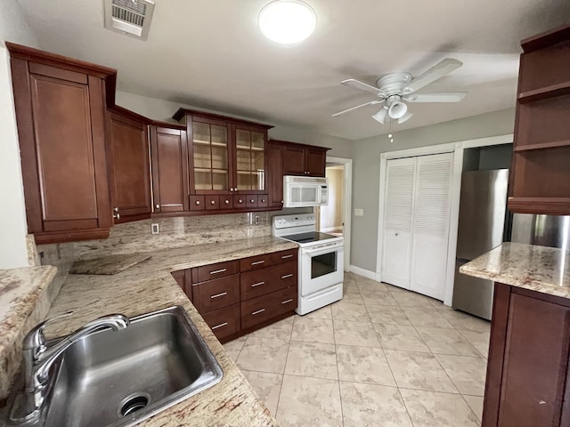 9319 Southampton Pl, Boca Raton, FL 33434 - kitchen with white appliances, a sink, a ceiling fan, glass insert cabinets, and open shelves