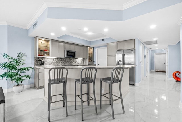 2650 Lake Shore Dr Unit 406, Riviera Beach, FL 33404 - kitchen featuring appliances with stainless steel finishes, gray cabinets, light marble finish flooring, crown molding, and a breakfast bar area