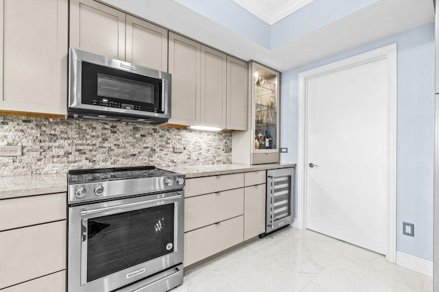 2650 Lake Shore Dr Unit 406, Riviera Beach, FL 33404 - kitchen featuring stainless steel appliances, ornamental molding, wine cooler, light marble finish floors, and decorative backsplash