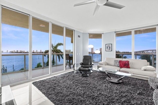 2650 Lake Shore Dr Unit 406, Riviera Beach, FL 33404 - tiled living room with a wall of windows, a water view, and a ceiling fan