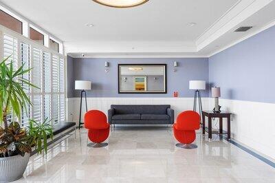2650 Lake Shore Dr Unit 406, Riviera Beach, FL 33404 - common area with wainscoting and crown molding