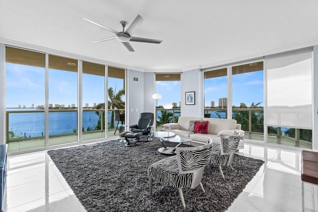 2650 Lake Shore Dr Unit 406, Riviera Beach, FL 33404 - living room featuring floor to ceiling windows, ceiling fan, a water view, and tile patterned floors