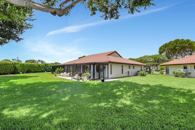 5319 Palmetto Palm Ct Unit A, Boynton Beach, FL 33437 - rear view of property featuring a tile roof, a yard, a sunroom, and stucco siding