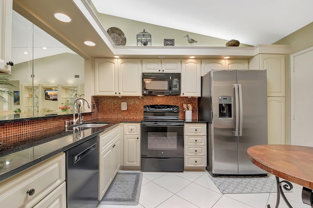5319 Palmetto Palm Ct Unit A, Boynton Beach, FL 33437 - kitchen with black appliances, vaulted ceiling, decorative backsplash, light tile patterned floors, and recessed lighting