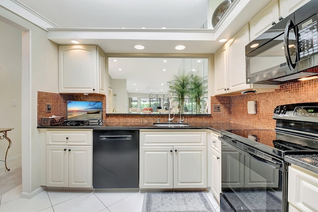 5319 Palmetto Palm Ct Unit A, Boynton Beach, FL 33437 - kitchen with black appliances, dark countertops, tasteful backsplash, white cabinetry, and light tile patterned floors