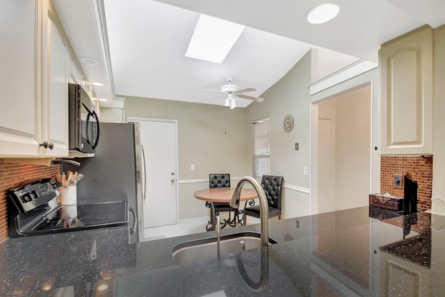 5319 Palmetto Palm Ct Unit A, Boynton Beach, FL 33437 - kitchen with black / electric stove, a skylight, tasteful backsplash, ceiling fan, and dark stone countertops