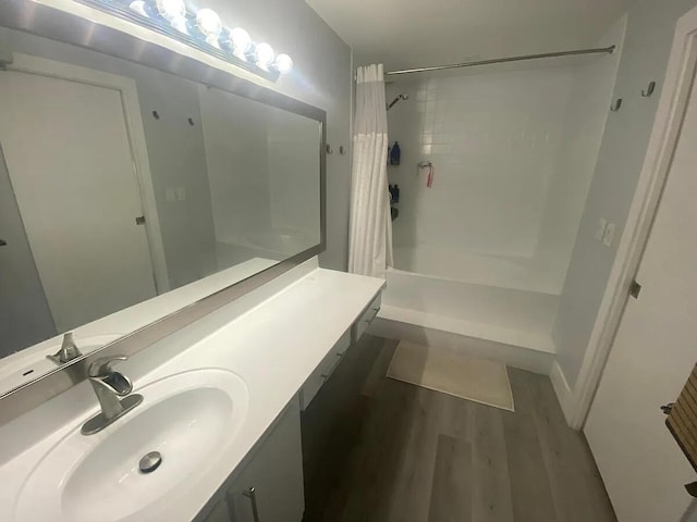 637 Executive Center Dr Unit N207, West Palm Beach, FL 33401 - bathroom with shower / bath combo with shower curtain, wood finished floors, and vanity