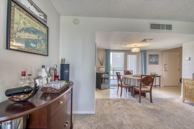 336 Golfview Rd Unit 518, North Palm Beach, FL 33408 - dining room with light tile patterned floors, light colored carpet, a textured ceiling, and baseboards