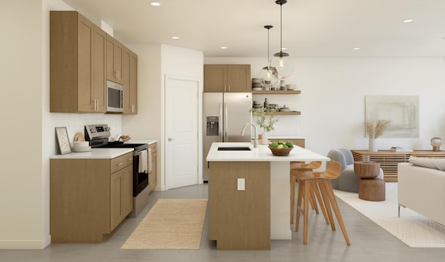 4572 SW Savona Blvd Unit 16, Port Saint Lucie, FL 34953 - kitchen featuring appliances with stainless steel finishes, a kitchen bar, a sink, light countertops, and decorative light fixtures