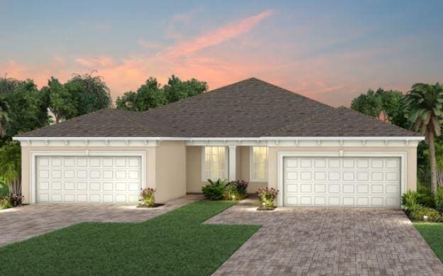 12755 SW Cattleya Ln Unit 224, Port Saint Lucie, FL 34987 - single story home with a garage, decorative driveway, a front yard, a shingled roof, and stucco siding