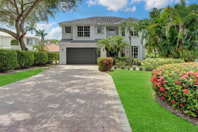 4220 NW 58th Ln, Boca Raton, FL 33496 - view of front of home featuring a garage, decorative driveway, a tile roof, and a front yard