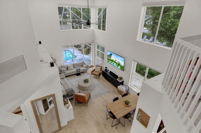 4220 NW 58th Ln, Boca Raton, FL 33496 - living room with a towering ceiling, healthy amount of natural light, wood finished floors, and a ceiling fan