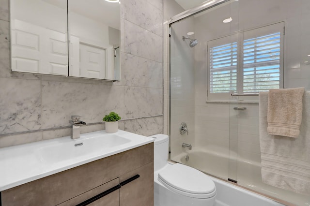 4220 NW 58th Ln, Boca Raton, FL 33496 - bathroom with combined bath / shower with glass door, tile walls, and vanity