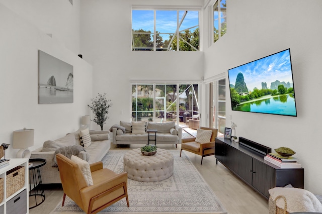 4220 NW 58th Ln, Boca Raton, FL 33496 - living area featuring a high ceiling and light wood-style flooring
