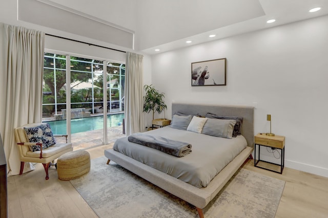 4220 NW 58th Ln, Boca Raton, FL 33496 - bedroom featuring access to exterior, recessed lighting, wood finished floors, and a towering ceiling